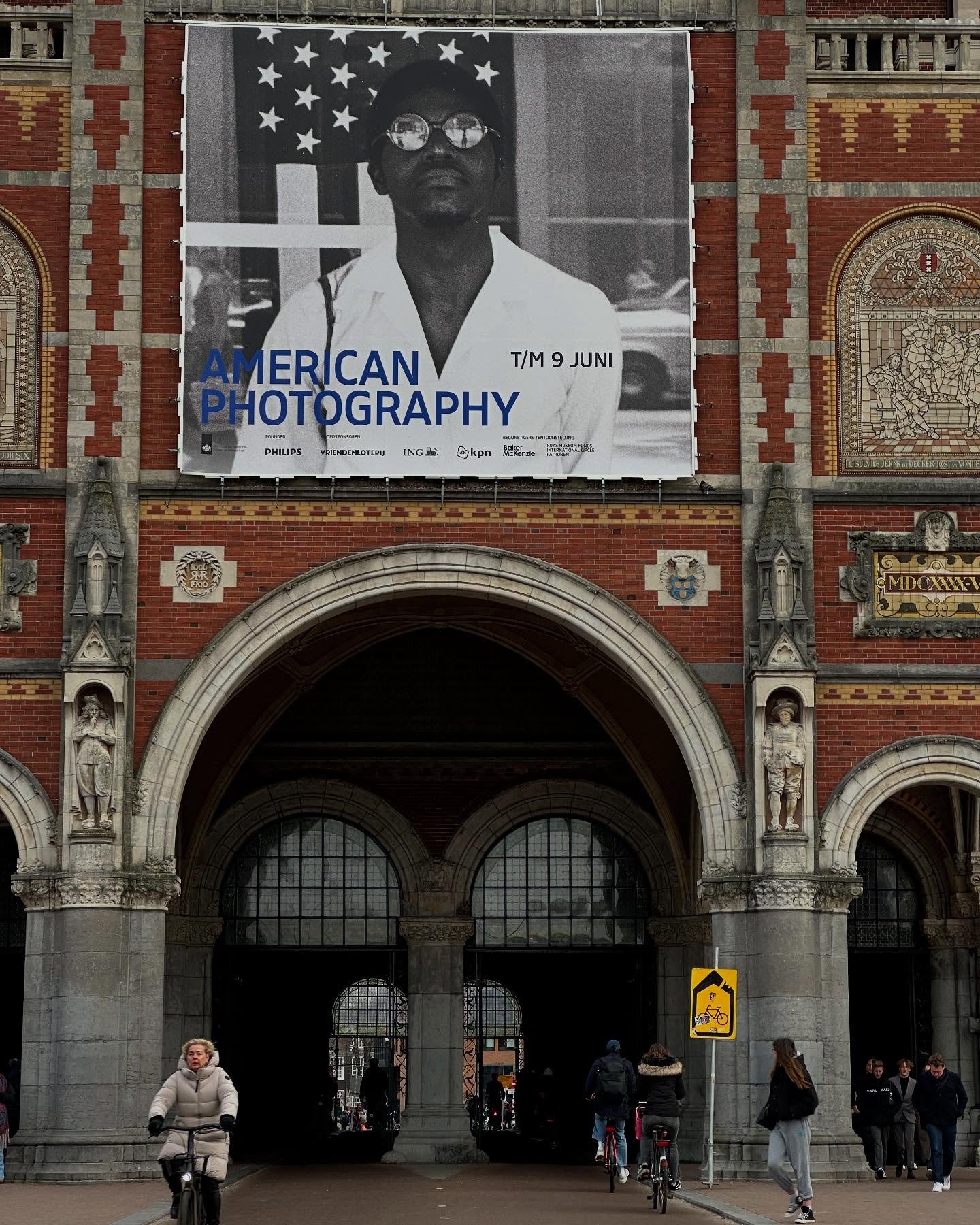 American Photography Exhibition Banner at a Historic Arched Entrance