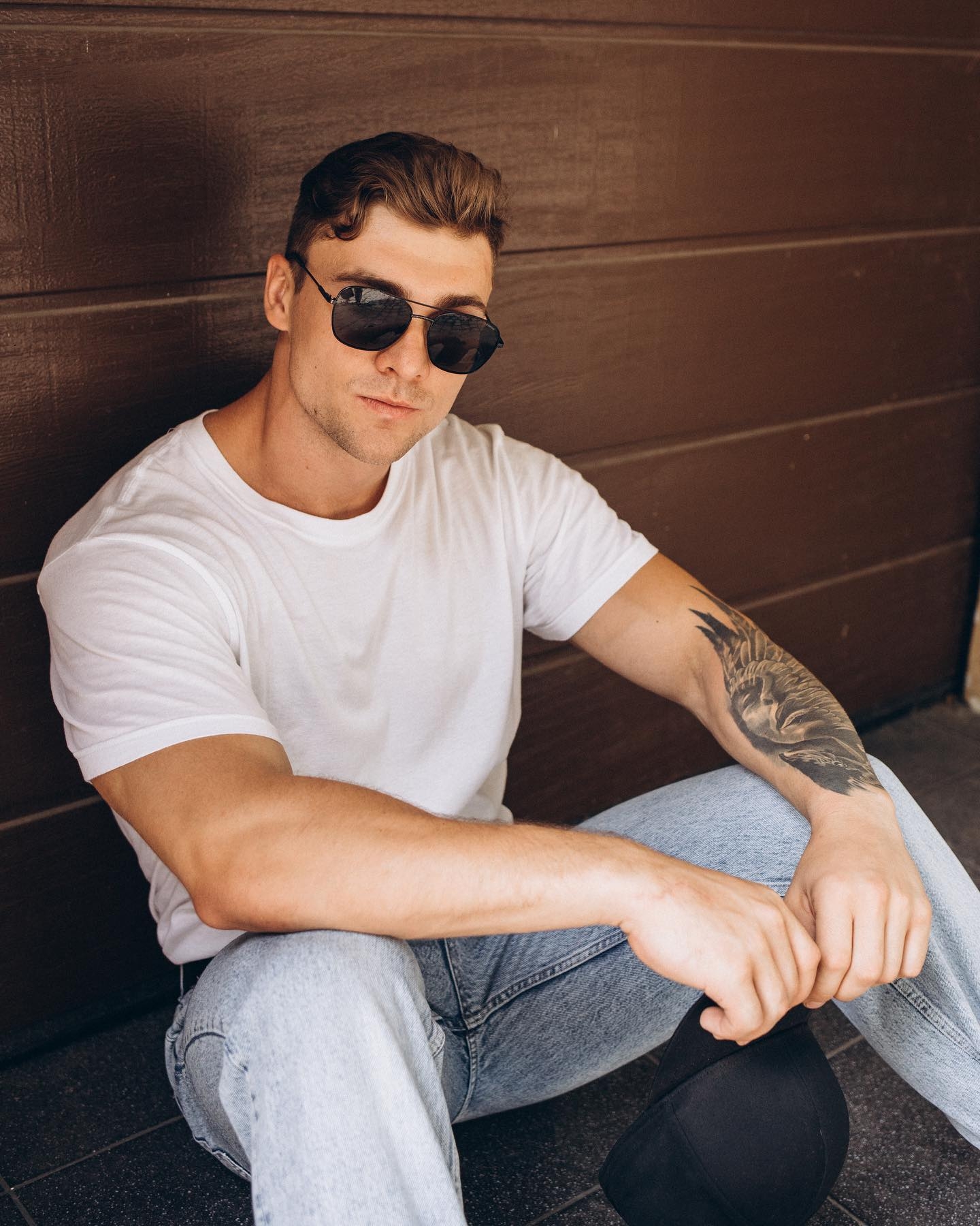 Confident Pose: Athlete's Portrait with Tattoos and Personal Style