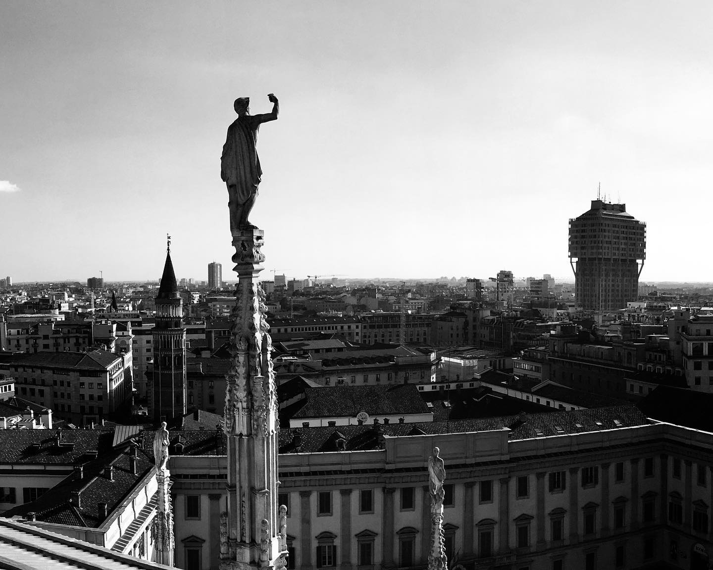 Eternal Vigil: Milan's Skyline and Statue