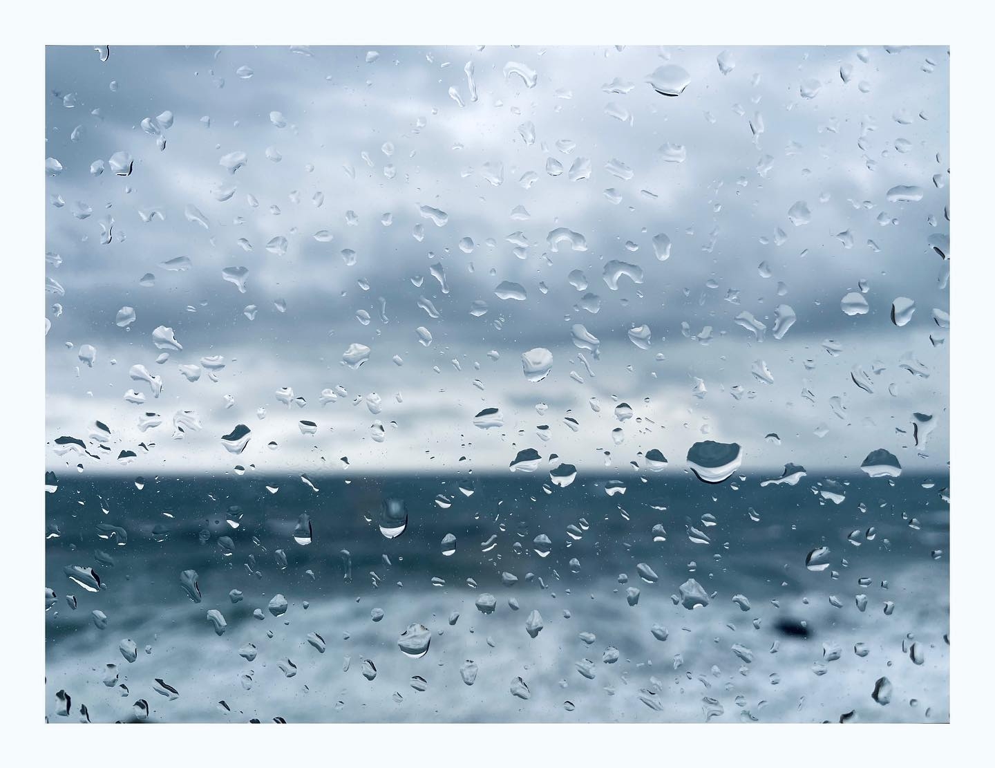 Serene Raindrops: Ocean Through the Glass