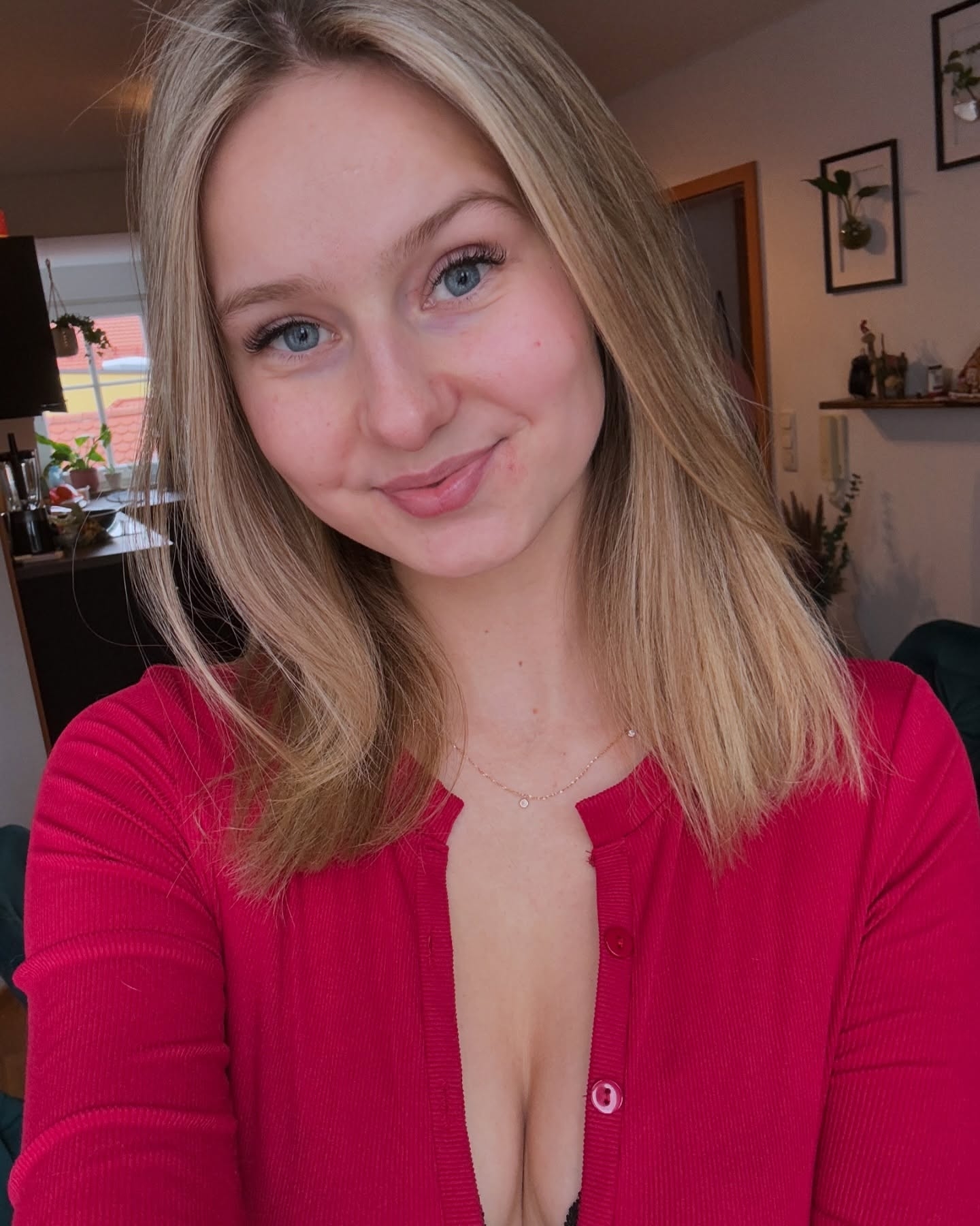 Confident Professional Portrait with Red Cardigan and Elegant Necklace