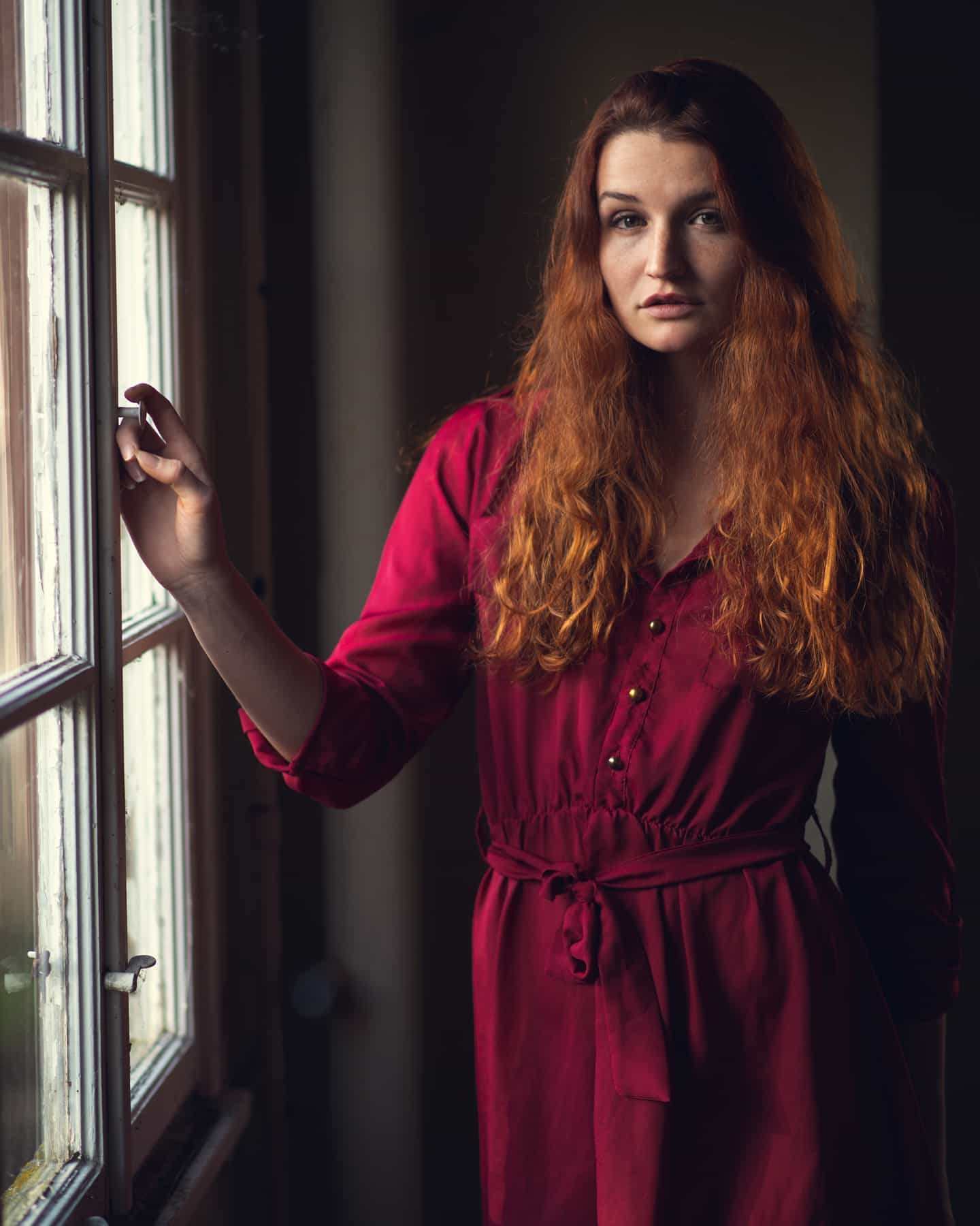 Contemplative Red: Intimate Portrait by Window
