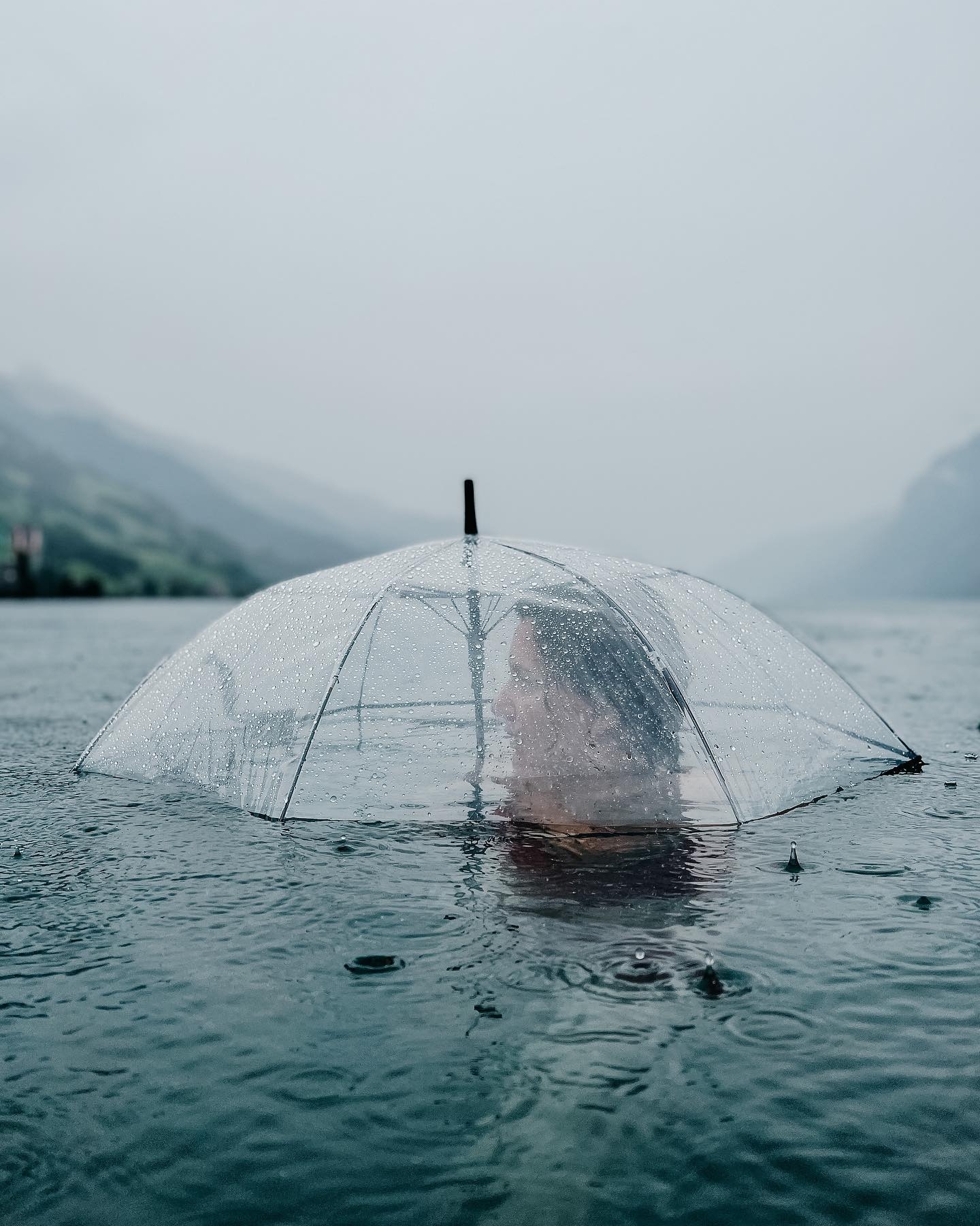 Contemplative Rain: A Figure in a Transparent Umbrella