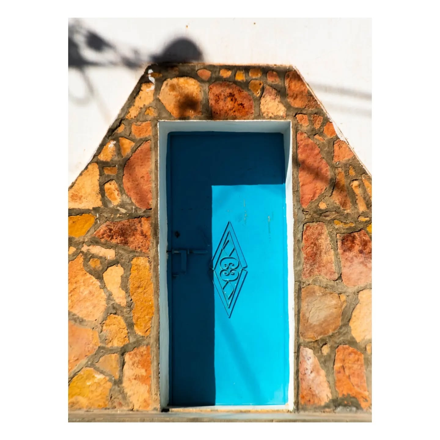 Vibrant Blue Minimalist Doorway in Stone Arch